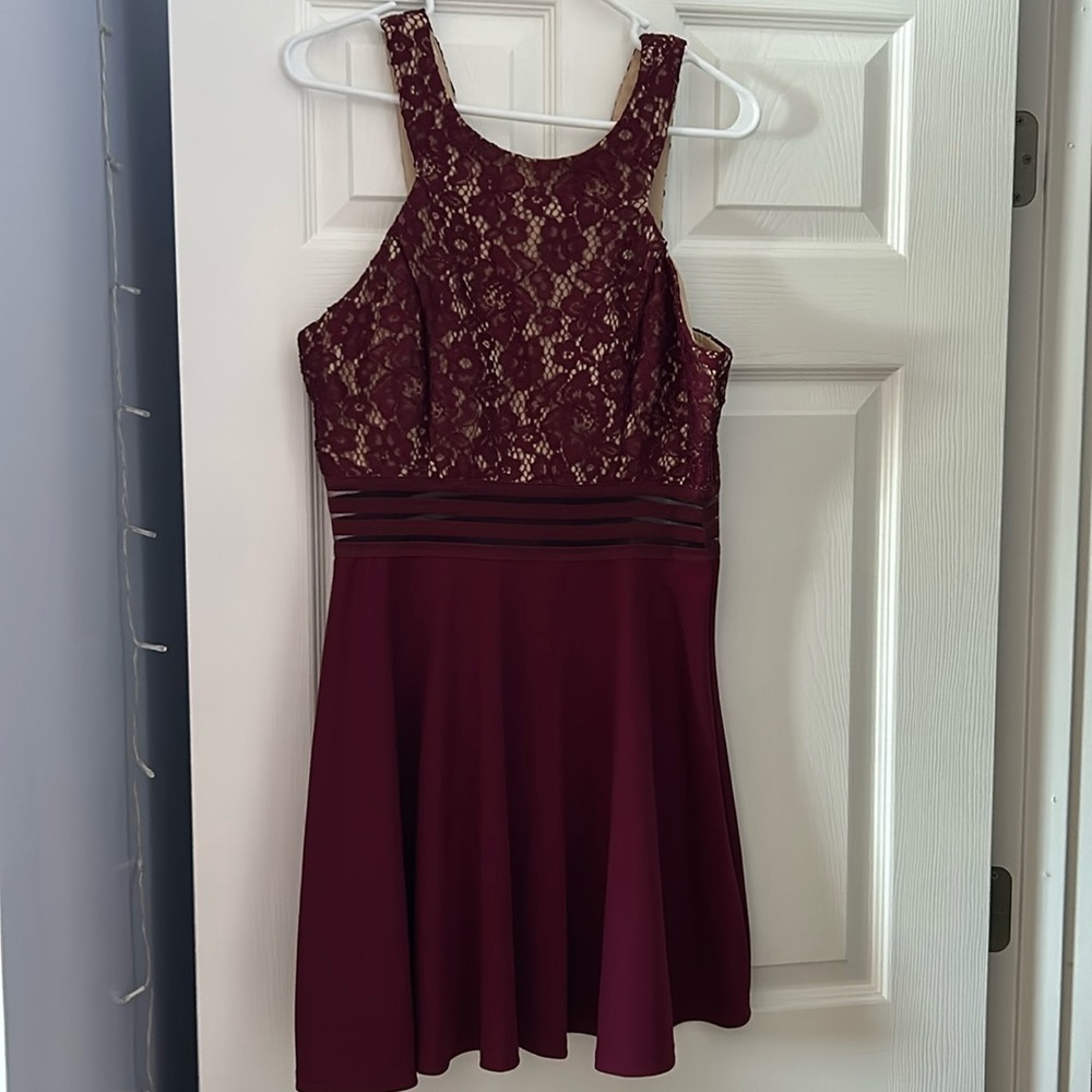 It is a size 13 in the juniors, brand is Speechless. The color is maroon.